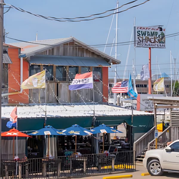 Crazy Alan's Swamp Shack, a vibrant Cajun restaurant with outdoor seating and marina views.