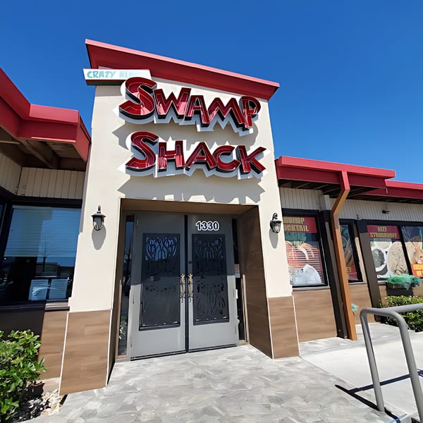 The exterior of Crazy Alan's Swamp Shack, a cajun restaurant, with its red and white sign.
